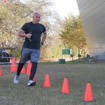Participant running serpentine through cones