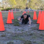 Participant crawling under cones