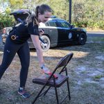 Person placing handgun on chair