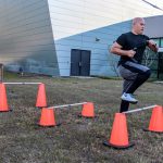Participant stepping over hurdles